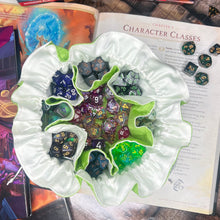 Load image into Gallery viewer, A green and white dice bag is closed on a gaming table with a dice tray and D&D books in the background.