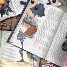 Load and play video in Gallery viewer, An open dice bag is set on a D&D book, the drawstring pulled, and the cord wrapped around the top.
