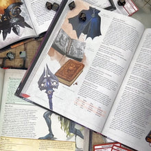 Load and play video in Gallery viewer, An open dice bag is set on a D&D book, the drawstring pulled, and the cord wrapped around the top.