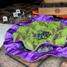 Load image into Gallery viewer, A green and purple dice bag lays flat on a D&amp;D map.
