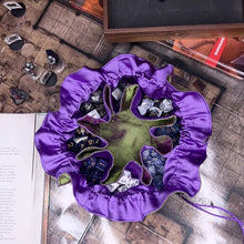 Load and play video in Gallery viewer, An open dice bag is set on a D&amp;D book, the drawstring pulled, and the cord wrapped around the top.
